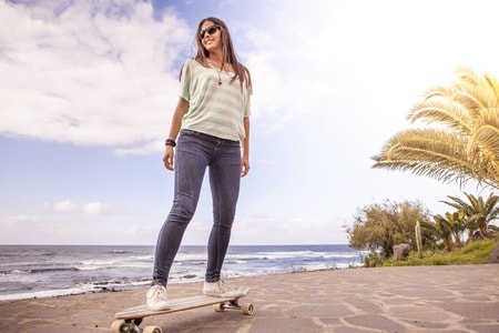 female skateboarding beach