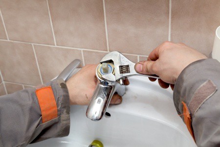 plumber fixing sink