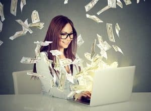  Lady on computer system with cash drifting around her