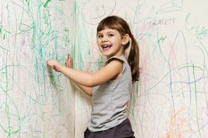 Girl,Drawing,With,Crayons,On,The,Wallpaper