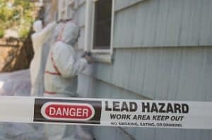 Two,House,Painters,In,Hazmat,Suits,Removing,Lead,Paint,From