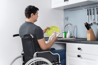 Man in wheelchair in kitchen shutterstock_1653112525