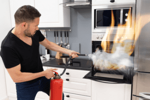 Using fire extinguisher to put out oven fire shutterstock_1769700197