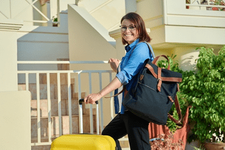 Woman with suitcase shutterstock_2071949090