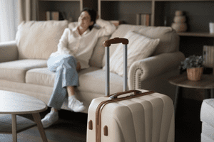 Airbnb with suitcase shutterstock_2130114923