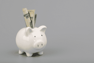 Piggy bank with money shutterstock_1544239664