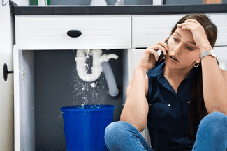 Woman calling about leaky sink shutterstock_1760535575