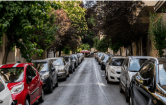 Cars parked on city street shutterstock_1756113359