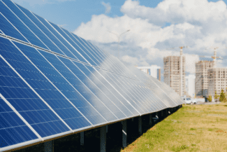 Solar panels on apt bldg Shutterstock_2200500583
