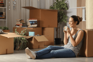 Woman with moving boxes Shutterstock_1414028594