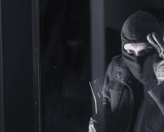 Burglar looking in window Shutterstock_165378140