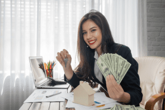 Lady with money Shutterstock_1701428797
