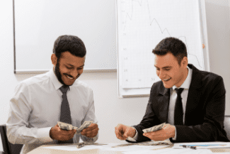 Businessmen counting money Shutterstock_276668510
