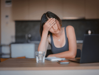 Overwhelmed lady at computer Shutterstock_2184947279