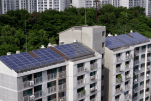 Solar panels on apt building Shutterstock_698820625