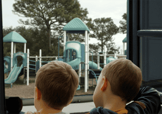 Children looking out at playground