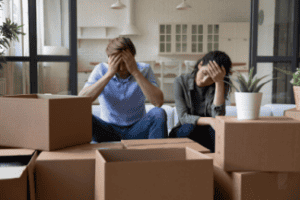 Unhappy moving couple Shutterstock_2067029414