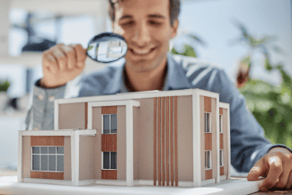 Examining a model of a building Shutterstock_2325390285