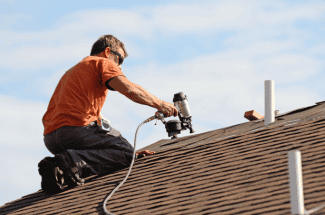 Roofer on roof Shutterstock_169825319