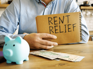 Man with rent relief sign Shutterstock_1806600229