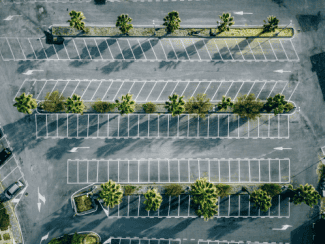 Overhead view of empty parking lot Shutterstock_1680235069