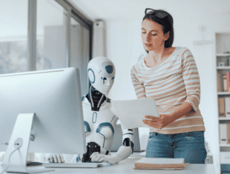 AI robot at computer Shutterstock_2401060007