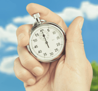 Hand holding time clock Shutterstock_1897059583