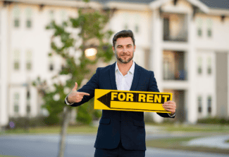Man with for rent sign Shutterstock_2420148393