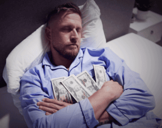 Sleeping man with money Shutterstock_2319032475