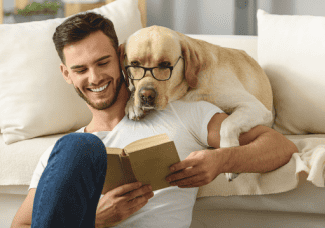 Dog reading with glasses Shutterstock_499979275